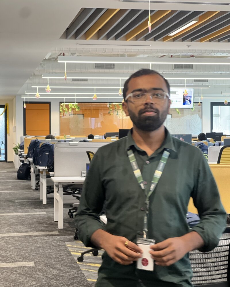 Swaroop on the floor of the multinational that hired him as an AI Engineer, badge on.
